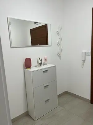 a bathroom with a mirror and a white dresser at Natalija Stan na dan in Banja Luka