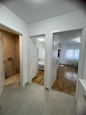 a white room with a hallway with a living room at Natalija Stan na dan in Banja Luka