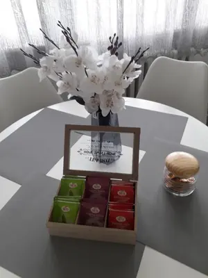 a table with a vase of flowers and a box of soap at VIEW APARTMENT in Visoko