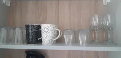 a shelf with cups and glasses on it at VIEW APARTMENT in Visoko