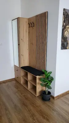 a wooden bench in a room with a potted plant at Apartman Gold in Bugojno