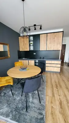 a dining room with a table and some chairs at Apartman Gold in Bugojno