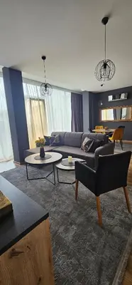 a living room with a couch and a table at Apartman Gold in Bugojno