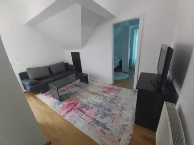 a living room with a couch and a television at Apartmani Sladojević in Mrkonjić Grad