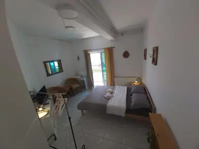 a bedroom with a bed and a window at Apartmani Sladojević in Mrkonjić Grad