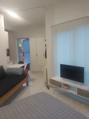 a living room with a couch and a flat screen tv at Apartmani Sladojević in Mrkonjić Grad