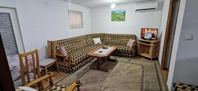 a living room with a couch and a table at Vikendica Delić Lukavac in Lukavac
