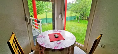 a table in front of a window with a red box at Vikendica Delić Lukavac in Lukavac