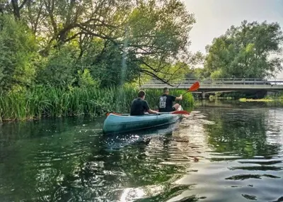 two people in a canoe on a river at Apartman Potok in Livno