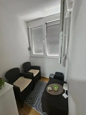 a small living room with chairs and a table at Bilino polje in Zenica