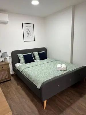 a bedroom with a bed with two shoes on it at Damade apartments in Jajce