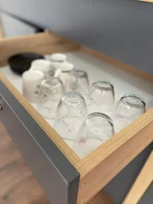 a wooden box with several empty wine glasses at Damade apartments in Jajce