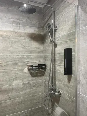a shower with a glass door in a bathroom at Damade apartments in Jajce