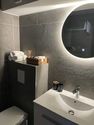 a bathroom with a white sink and a mirror at Damade apartments in Jajce