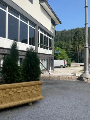 a building with a planter in front of a building at Damade apartments in Jajce