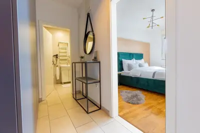 a bedroom with a bed and a mirror at Platinum_Luxury_Apartment in Teslić