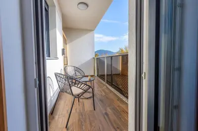 a balcony with a chair and a table at Platinum_Luxury_Apartment in Teslić