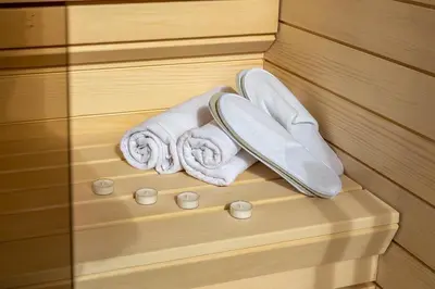 a pair of towels and two rolled towels in a sauna at Platinum_Luxury_Apartment in Teslić