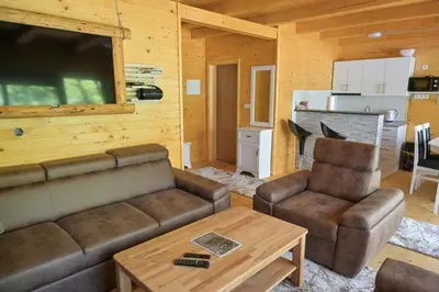 a living room with a couch and a table at Hakuna Matata Lake House in Jajce
