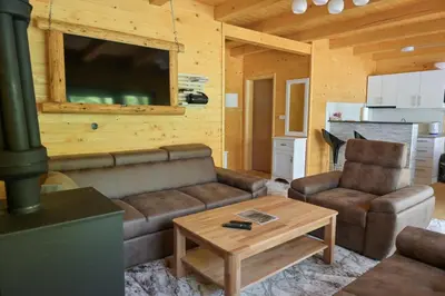 a living room with a couch and a coffee table at Hakuna Matata Lake House in Jajce