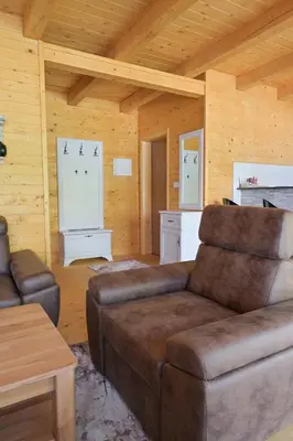 a living room with a couch and a table at Hakuna Matata Lake House in Jajce