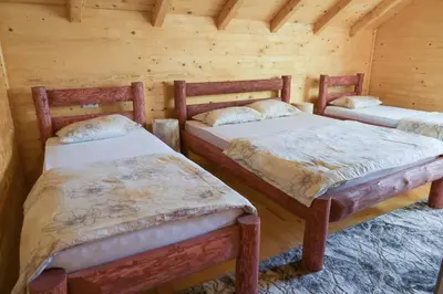 a room with two beds in a log cabin at Hakuna Matata Lake House in Jajce