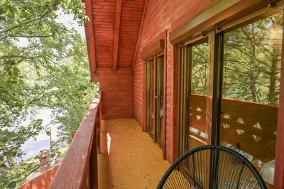 a porch of a house with a bench and windows at Hakuna Matata Lake House in Jajce