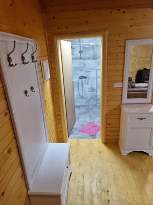 a bathroom with a shower in a wooden room at Hakuna Matata Lake House in Jajce