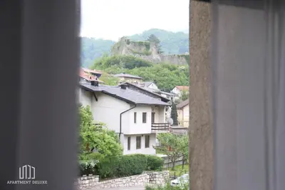 a view from a window of a town with a mountain at Apartment Deluxe in Jajce