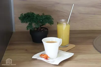 a cup of coffee and a drink on a table at Apartment Deluxe in Jajce
