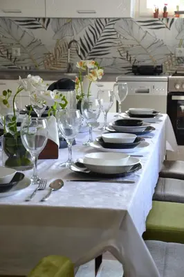 a table with plates and wine glasses on it at Villa River and Sky in Bihać