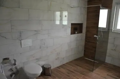 a bathroom with a toilet and a shower at Villa River and Sky in Bihać