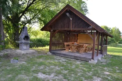 a small gazebo with a fireplace in a yard at Villa River and Sky in Bihać