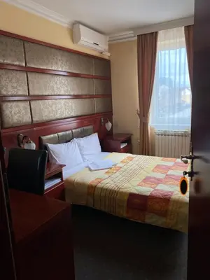 a hotel room with a bed and a window at Hotel Kamel in Banja Luka