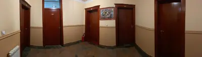 a hallway with three wooden elevators in a room at Hotel Kamel in Banja Luka