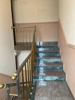a staircase in a building with a metal railing at Hotel Kamel in Banja Luka