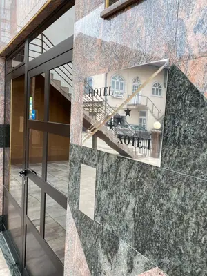 a sign for a hotel on the side of a building at Hotel Kamel in Banja Luka