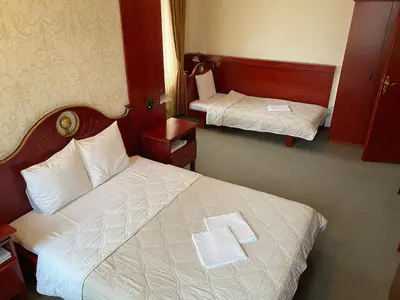 a hotel room with two beds with towels on them at Hotel Kamel in Banja Luka