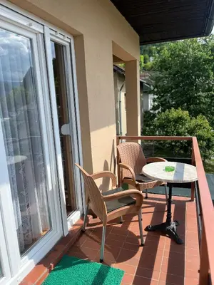 a patio with a table and chairs on a balcony at Apartment View in Jajce