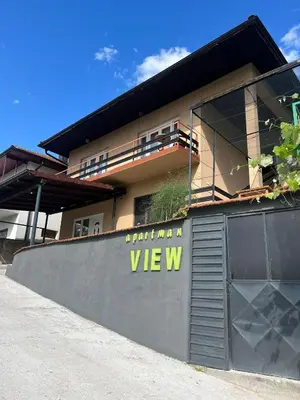 a building with a gate with a sign on it at Apartment View in Jajce