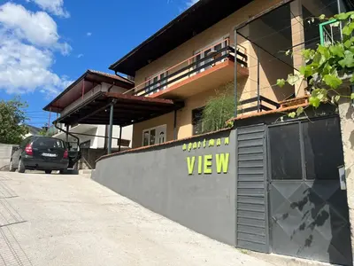 a building with a sign on the side of it at Apartment View in Jajce