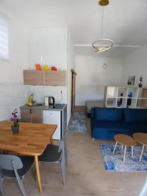a living room with a blue couch and a table at Apartment View in Jajce