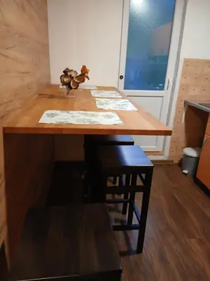 a wooden table in a room with a table with chairs at Apartment View in Jajce