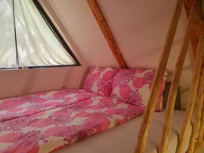 a bed in a small room with a window at Etno selo BISTROVO in Vitez