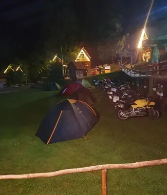 a group of tents on the grass at night at Etno selo BISTROVO in Vitez
