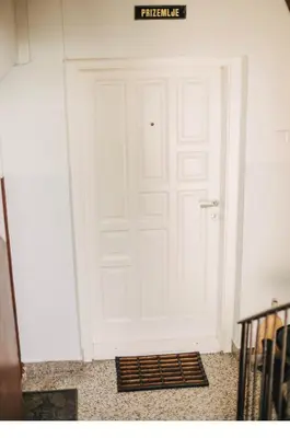 a white door with a sign on top of it at Apartman sunce Visoko in Visoko