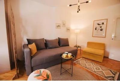 a living room with a couch and a table at Apartman sunce Visoko in Visoko