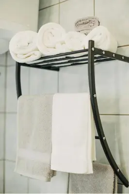 a towel rack with towels on it in a bathroom at Apartman sunce Visoko in Visoko