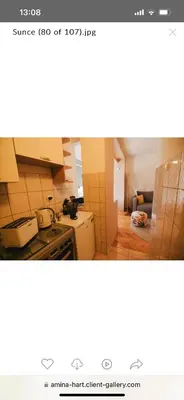 a small kitchen with a stove and a refrigerator at Apartman sunce Visoko in Visoko