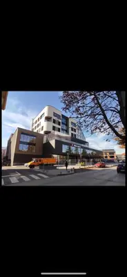 a large building with a street in front of it at Apartman sunce Visoko in Visoko